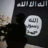 TOPSHOT - A member of the Iraqi forces walks past a mural bearing the logo of the Islamic State (IS) group in a tunnel that was reportedly used as a training centre by the jihadists, on March 1, 2017, in the village of Albu Sayf, on the southern outskirts of Mosul. Iraqi forces launched a major push on February 19 to recapture the west of Mosul from the Islamic State jihadist group, retaking the airport and then advancing north. (Photo by AHMAD AL-RUBAYE / AFP) (Photo by AHMAD AL-RUBAYE/AFP via Getty Images)