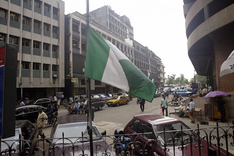 Lagos, NIGERIA: A Nigerian flag flies at half mast at a Lagos public building 24 October 2005. The Nigerian government has declared a three-day national mourning in honour of 117 passengers who died in a Bellview air crash at Lissa village in Ifo district southwest Nigeria. (Photo credit should read PIUS UTOMI EKPEI/AFP via Getty Images)