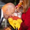 TOPSHOT - US President Joe Biden jokingly bites a baby dressed as a chicken as he hosts a Halloween trick-or-treat event at the South Portico of the White House in Washington, DC, on October 30, 2024. (Photo by Tierney CROSS / AFP) (Photo by TIERNEY CROSS/AFP via Getty Images)