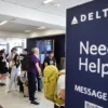 Travelers wait in line on the check-in floor of the Delta Air Lines terminal at Los Angeles International Airport (LAX) on July 23, 2024 in Los Angeles, California. Delta Air Lines is still reeling in the aftermath of the CrowdStrike outage with 24 flights cancelled and 27 flights delayed at LAX today and 434 cancelled Delta flights nationwide today. (Photo by Mario Tama/Getty Images)