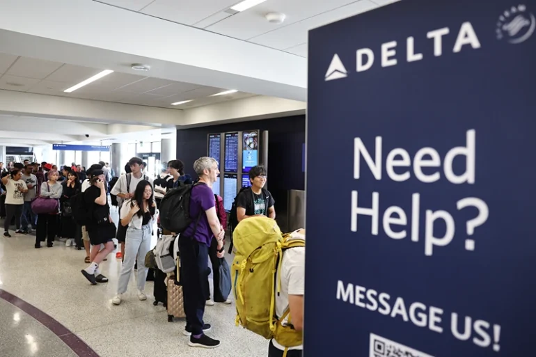 Travelers wait in line on the check-in floor of the Delta Air Lines terminal at Los Angeles International Airport (LAX) on July 23, 2024 in Los Angeles, California. Delta Air Lines is still reeling in the aftermath of the CrowdStrike outage with 24 flights cancelled and 27 flights delayed at LAX today and 434 cancelled Delta flights nationwide today. (Photo by Mario Tama/Getty Images)