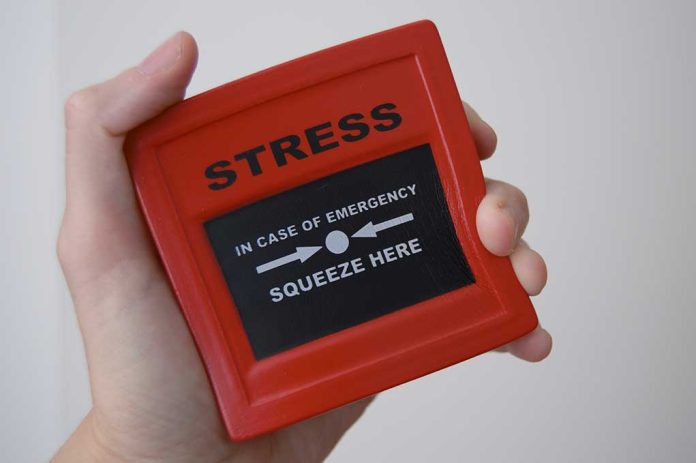 Hand holding red stress relief device