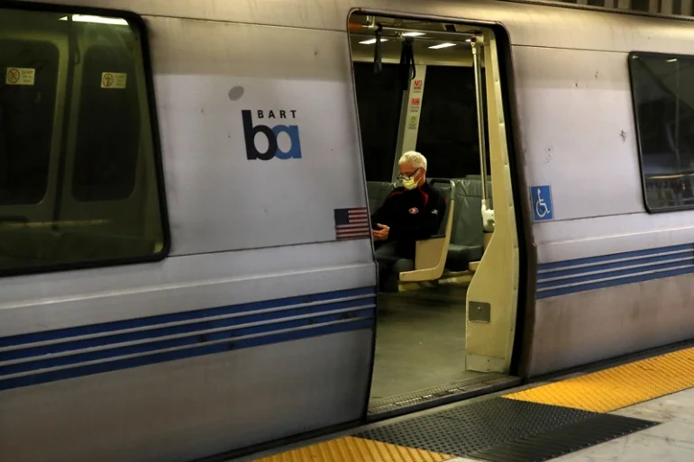 SAN FRANCISCO, CALIFORNIA - APRIL 08: A Bay Area Rapid Transit (BART) passenger rides in an empty train car on April 08, 2020 in San Francisco, California. BART announced that it is slashing daily service as ridership falls dramatically due to the coronavirus shelter in place order. Starting Wednesday, regular Monday through Friday service will be reduced to running trains every half hour between 5 am and 9 pm. (Photo by Justin Sullivan/Getty Images)