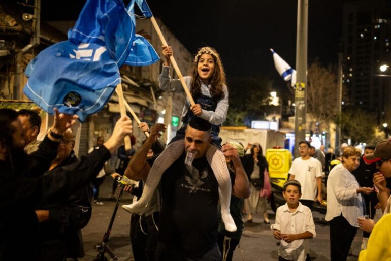 People celebrate after the Israeli military confirmed the death of Hamas leader Yahya Sinwar, in Jerusalem on October 17, 2024. The Israeli military said on October 17 its forces killed Hamas leader Yahya Sinwar in southern Gaza's Rafah, after a firefight with the militant leader and two other fighters the previous day. (Photo by JOHN WESSELS / AFP) (Photo by JOHN WESSELS/AFP via Getty Images)