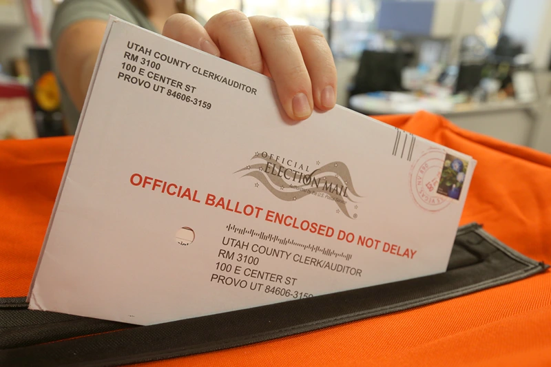 PROVO, UT - November 6: A employee at the Utah County Election office puts mail in ballots into a container to register the vote in the midterm elections on November 6, 2018 in Provo, Utah. Utah early voting has been the highest ever in Utah's midterm elections. One of the main proportions on the ballot in Utah is whether Utah will legalize medical marijuana. (Photo by George Frey/Getty Images)