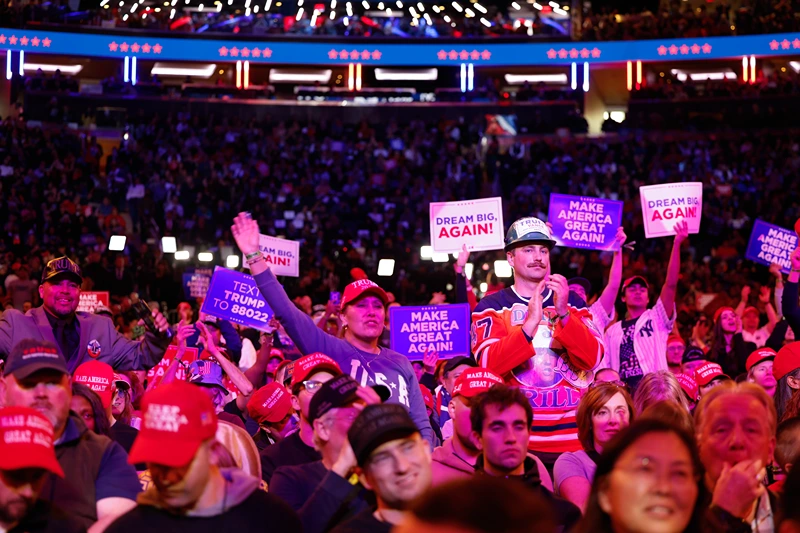 : Supporters of Republican presidential nominee, former U.S. President Donald Trump cheer speakers before he takes the stage at the campaign rally at Madison Square Garden on October 27, 2024 in New York City. Trump closed out his weekend of campaigning in New York City with a guest list of speakers that includes his running mate Republican vice presidential nominee, U.S. Sen. J.D. Vance (R-OH), Tesla CEO Elon Musk, UFC CEO Dana White, and House Speaker Mike Johnson (R-LA), among others, nine days before Election Day. (Photo by Anna Moneymaker/Getty Images)