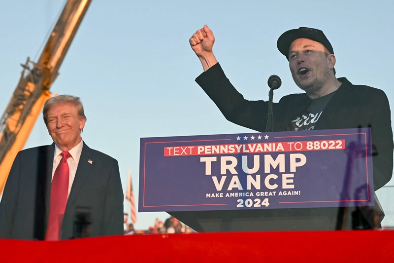 Tesla CEO Elon Musk (R) speaks on stage as he joins former US President and Republican presidential candidate Donald Trump during a campaign rally at site of his first assassination attempt in Butler, Pennsylvania on October 5, 2024. (Photo by Jim WATSON / AFP) (Photo by JIM WATSON/AFP via Getty Images)