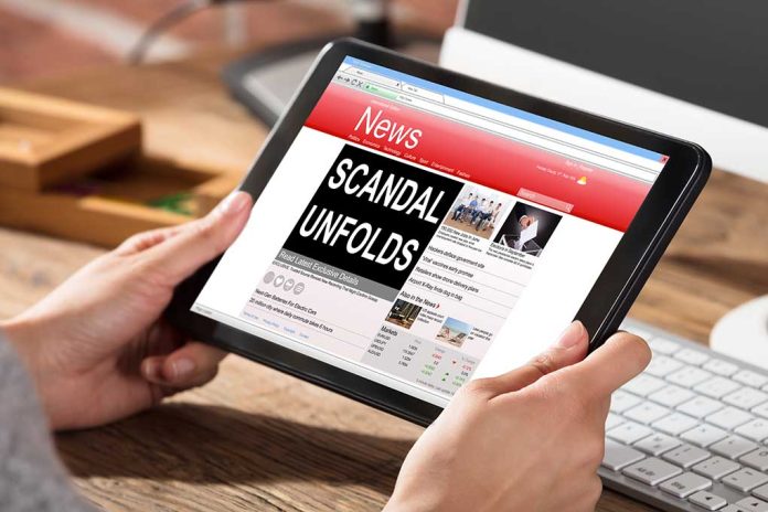 Person holding tablet displaying news headline Scandal Unfolds