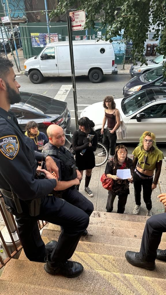 A group of people who were allegedly squatting talk to the police outside of 60 South 4th street In Williamsburg, Brooklyn after being removed from a vacant brownstone.