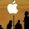 Customers walk past an Apple logo inside of an Apple store at Grand Central Station in New York, U.S., August 1, 2018. REUTERS/Lucas Jackson/File Photo