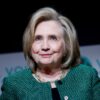 Hillary Clinton delivering a speech at the Vital Voices Global Festival in Washington, DC, wearing a green jacket