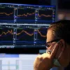 A trader works on the trading floor on the last day of trading before Christmas at the New York Stock Exchange (NYSE) in Manhattan, New York City, U.S., December 23, 2021. REUTERS/Andrew Kelly/File Photo