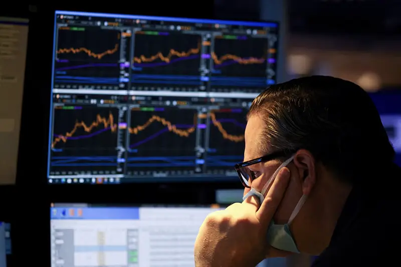 A trader works on the trading floor on the last day of trading before Christmas at the New York Stock Exchange (NYSE) in Manhattan, New York City, U.S., December 23, 2021. REUTERS/Andrew Kelly/File Photo