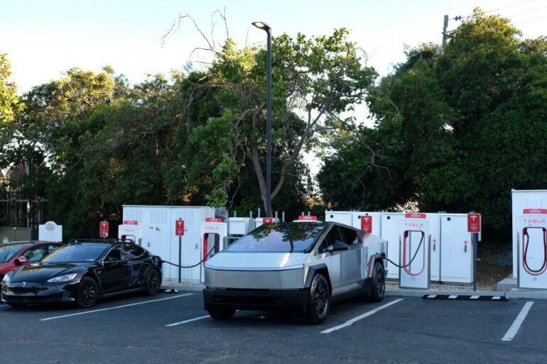 A Cybertruck charges at Tesla station.