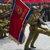 Soldiers marching with flag in military parade