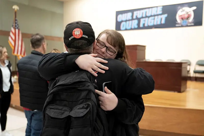 Members of the International Association of Machinists and Aerospace Workers District 751, embrace at a union hall after learning that union members voted to approve a new contract proposal from Boeing in Seattle, Washington, U.S. November 4, 2024. REUTERS/David Ryder Purchase Licensing Rights, opens new tab