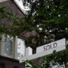 A "sold" sign is seen outside of a recently purchased home in Washington, U.S., July 7, 2022. REUTERS/Sarah Silbiger/File Photo