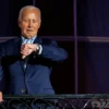 WASHINGTON, DC - JULY 04: President Joe Biden checks his watch as he steps out onto the balcony of the White House to view the fireworks over the National Mall during a 4th of July event on the South Lawn of the White House on July 4, 2024 in Washington, DC. The President is hosting the Independence Day event for members of the military and their families. (Photo by Samuel Corum/Getty Images)