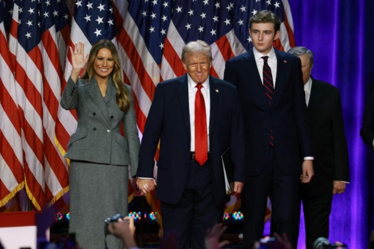 WEST PALM BEACH, FLORIDA - NOVEMBER 06: Republican presidential nominee, former U.S. President Donald Trump arrives to speak with former first lady Melania Trump and Barron Trump during an election night event at the Palm Beach Convention Center on November 06, 2024 in West Palm Beach, Florida. Americans cast their ballots today in the presidential race between Republican nominee former President Donald Trump and Vice President Kamala Harris, as well as multiple state elections that will determine the balance of power in Congress. (Photo by Joe Raedle/Getty Images)