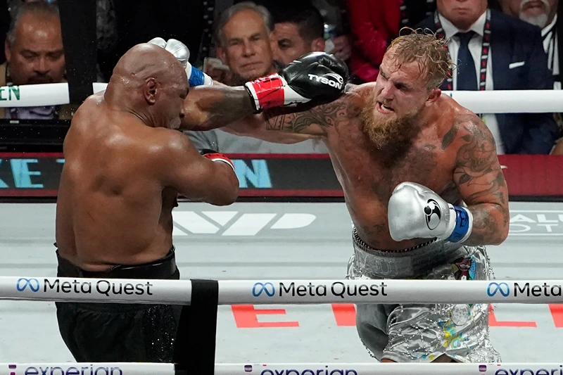 US retired pro-boxer Mike Tyson (L) and US YouTuber/boxer Jake Paul (R) fight during the heavyweight boxing bout at The Pavilion at AT&T Stadium in Arlington, Texas, November 15, 2024. (Photo by TIMOTHY A. CLARY / AFP) (Photo by TIMOTHY A. CLARY/AFP via Getty Images)