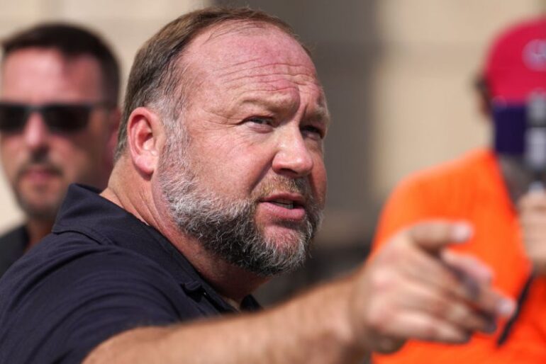 WATERBURY, CONNECTICUT - SEPTEMBER 21: InfoWars founder Alex Jones speaks to the media outside Waterbury Superior Court during his trial on September 21, 2022 in Waterbury, Connecticut. Jones is being sued by several victims' families for causing emotional and psychological harm after they lost their children in the Sandy Hook massacre. A Texas jury last month ordered Jones to pay $49.3 million to the parents of 6-year-old Jesse Lewis, one of 26 students and teachers killed in the shooting in Newtown, Connecticut. (Photo by Joe Buglewicz/Getty Images)