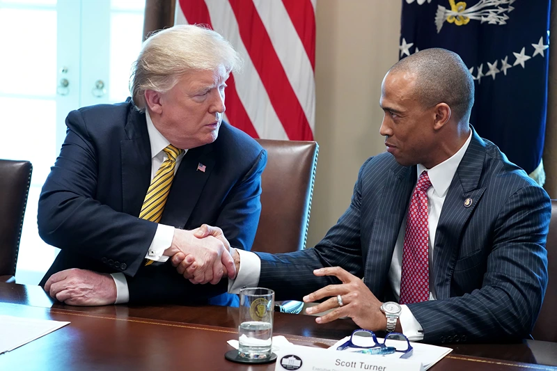 President Donald Trump makes shakes hands with White House Opportunity and Revitalization Council Executive Director Scott Turner during the inaugural meeting of the council in the Cabinet Room at the White House April 04, 2019 in Washington, DC. The council was formed to carry out the Trump administration’s plan "to encourage public and private investment in urban and economically distressed areas, including qualified opportunity zones," according to the White House. (Photo by Chip Somodevilla/Getty Images)