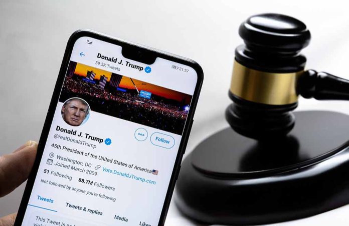 Smartphone displaying Twitter profile beside a judge’s gavel