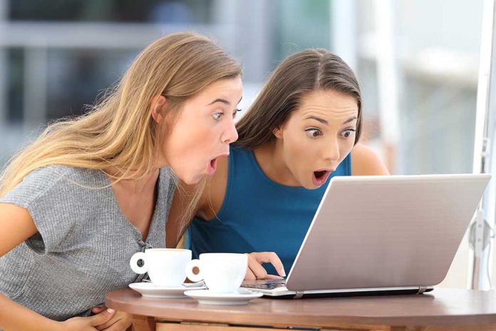 Two women surprised while looking at a laptop