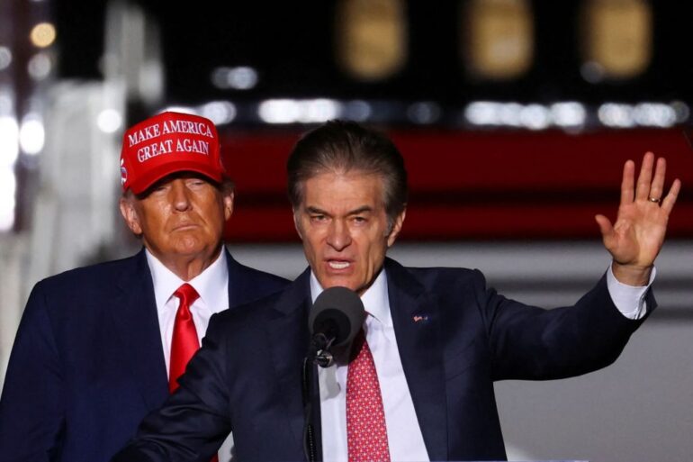 Former President Donald Trump looks on as then- Pennsylvania US Senate candidate Dr. Mehmet Oz  speaks at a pre-election rally in Latrobe, PA. on Nov. 5, 2022.