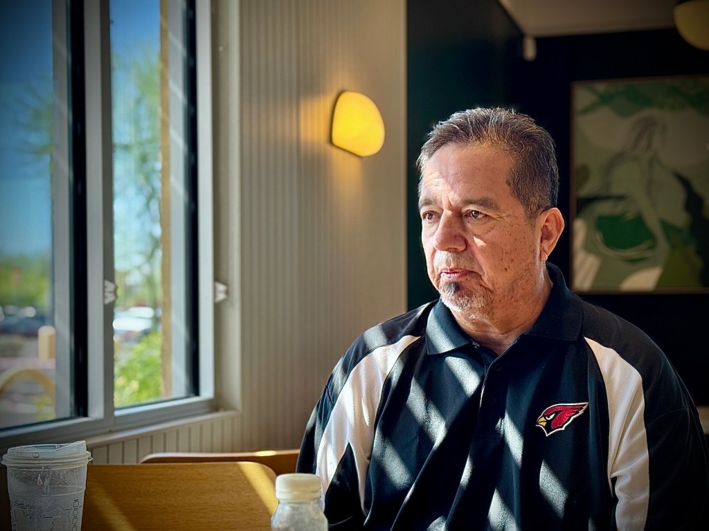 Raymond Sena sitting at a table, in conversation with NY Post columnist Justin Johnson, taken on November 4, 2024