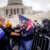 Rioters try to break through a police barrier at the Capitol on Jan. 6, 2021, in Washington