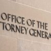 Office of the Attorney General sign on concrete wall.