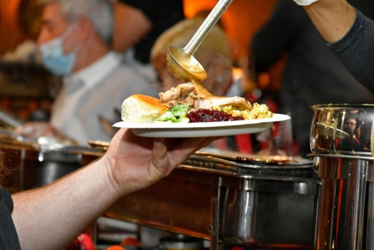 WEST HOLLYWOOD, CALIFORNIA - NOVEMBER 25: A guest enjoying Thanksgiving dinner at the Laugh Factory's 41st free Thanksgiving dinner at The Laugh Factory on November 25, 2021 in West Hollywood, California. (Photo by Michael Tullberg/Getty Images)