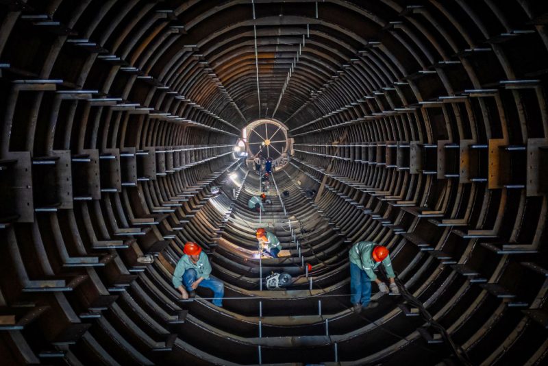 TOPSHOT - Employees work on a steel tube tower production line at a factory in Haian, in eastern China's Jiangsu province on September 1, 2024. (Photo by AFP) / China OUT (Photo by STR/AFP via Getty Images)