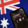 Facebook, Instagram and TikTok apps are seen on a smartphone in front of an Australian flag, in this illustration taken November 29, 2024. REUTERS/Edgar Su/Illustration