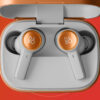 The B&O Beoplay Eleven earphones on orange and red background