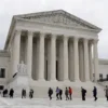 People walk across the plaza of the U.S. Supreme Court building on the first day of the court's new term in Washington, U.S. October 3, 2022. REUTERS/Jonathan Ernst/File Photo