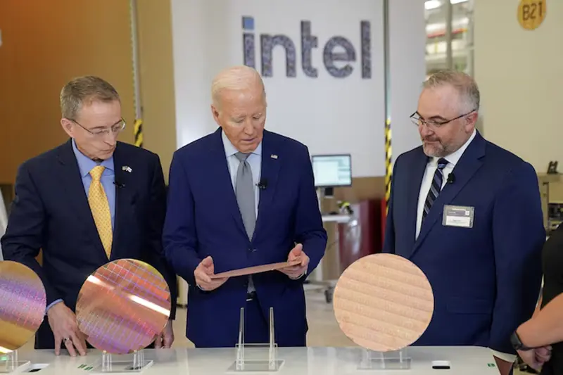 U.S. President Joe Biden looks at a wafer, as he tours the Intel Ocotillo Campus, in Chandler, Arizona, U.S., March 20, 2024. REUTERS/Kevin Lamarque/File Photo