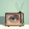 An old-style television with an eye looking out from it, implying the viewer is being watched