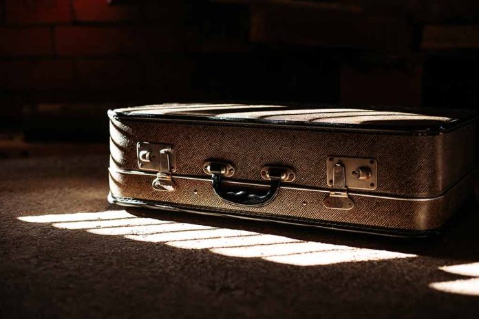 Brown suitcase in dimly lit room