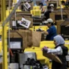 Workers select products during Cyber Monday at the Amazon's fulfillment center in Robbinsville, New Jersey, U.S., December 2, 2024. REUTERS