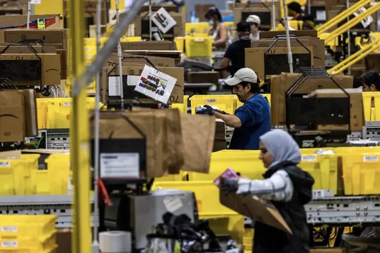 Workers select products during Cyber Monday at the Amazon's fulfillment center in Robbinsville, New Jersey, U.S., December 2, 2024. REUTERS