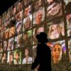 TOPSHOT - An Ultra-Orthodox Jewish man walks outside the walls of the old city of Jerusalem, on which are projected pictures of the hostages abducted by Palestinian militants on the October 7 attack and currently held in the Gaza Strip, on November 6, 2023, amid the ongoing battles between Israel and the militant group Hamas. (Photo by AHMAD GHARABLI / AFP) (Photo by AHMAD GHARABLI/AFP via Getty Images)