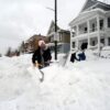 BUFFALO, NY - DECEMBER 27: Luke Bennett helps to clear heavy snow for his neighbors along South Park Avenue on December 27, 2022 in Buffalo, New York. The historic winter storm Elliott dumped up to four feet of snow, leaving thousands without power and at least 28 confirmed dead in the city of Buffalo and the surrounding suburbs. (Photo by John Normile/Getty Images)