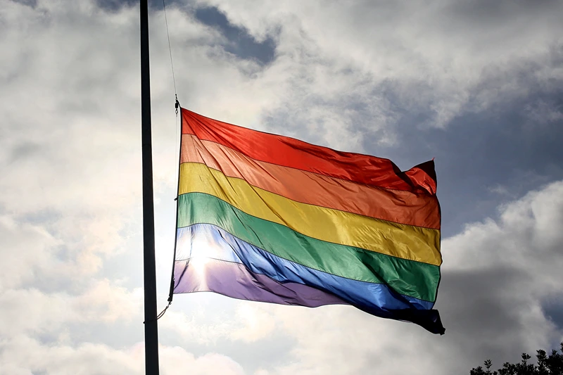 A pride flag stands a half mast during a memorial service in San Diego, California on June 12, 2016, for the victims of the Orlando Nighclub shooting. Fifty people died when a gunman allegedly inspired by the Islamic State group opened fire inside a gay nightclub in Florida, in the worst terror attack on US soil since September 11, 2001. (Photo by Sandy Huffaker / AFP) (Photo by SANDY HUFFAKER/AFP via Getty Images)