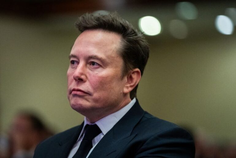 TOPSHOT - Elon Musk listens as US President-elect Donald Trump speaks during a meeting with House Republicans at the Hyatt Regency hotel in Washington, DC on November 13, 2024. (Photo by Allison ROBBERT / POOL / AFP) (Photo by ALLISON ROBBERT/POOL/AFP via Getty Images)