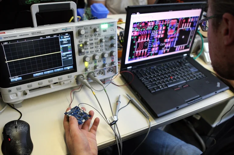 BERLIN, GERMANY - DECEMBER 27: A particpant checks a circuit board next to an oscilloscope on the first day of the 28th Chaos Communication Congress (28C3) - Behind Enemy Lines computer hacker conference on December 27, 2011 in Berlin, Germany. The Chaos Computer Club is Europe's biggest network of computer hackers and its annual congress draws up to 3,000 participants. (Photo by Adam Berry/Getty Images)