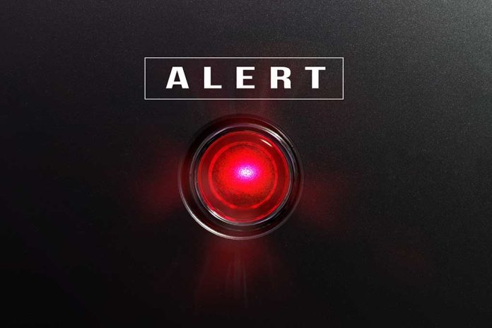 Red alert button on black background.