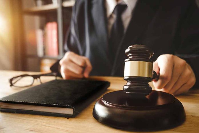 Judge holding gavel at desk