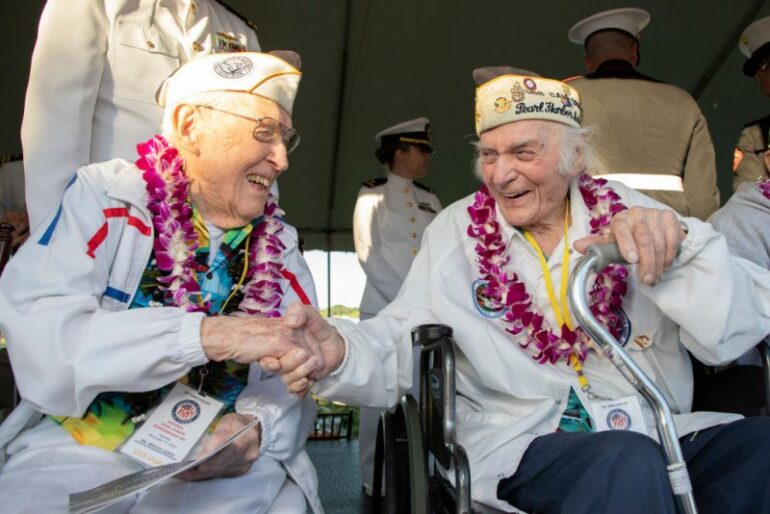 HONOLULU, HI - DECEMBER 07: One Hundred-year-old Veteran Warren Upton, from the USS Utah, wishes happy birthday to and Pearl harbor survivor, Navy Chief, Joseph Mariani, who turns 100 on December 12th as Pearl Harbor Commemorates the 78th Anniversary Of World War II Attacks at the Pearl Harbor National Memorial on December 7, 2019 in Honolulu, Hawaii. On the morning of December 7, 1941 the Japanese mounted a surprise military air strike on the naval base at Pearl Harbor leading to the United States' formal entry into World War II the next day. 2,335 were killed in the attack and dozens of naval ships were damaged or sunk. (Photo by Kat Wade/Getty Images)